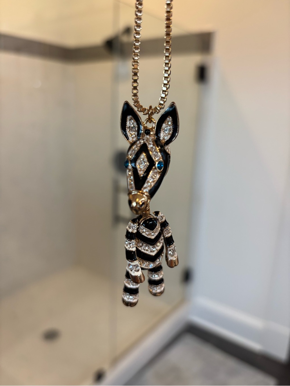 Enamel Zebra Pendant Necklace with Rhinestones - Black & Gold
30 inch chain.